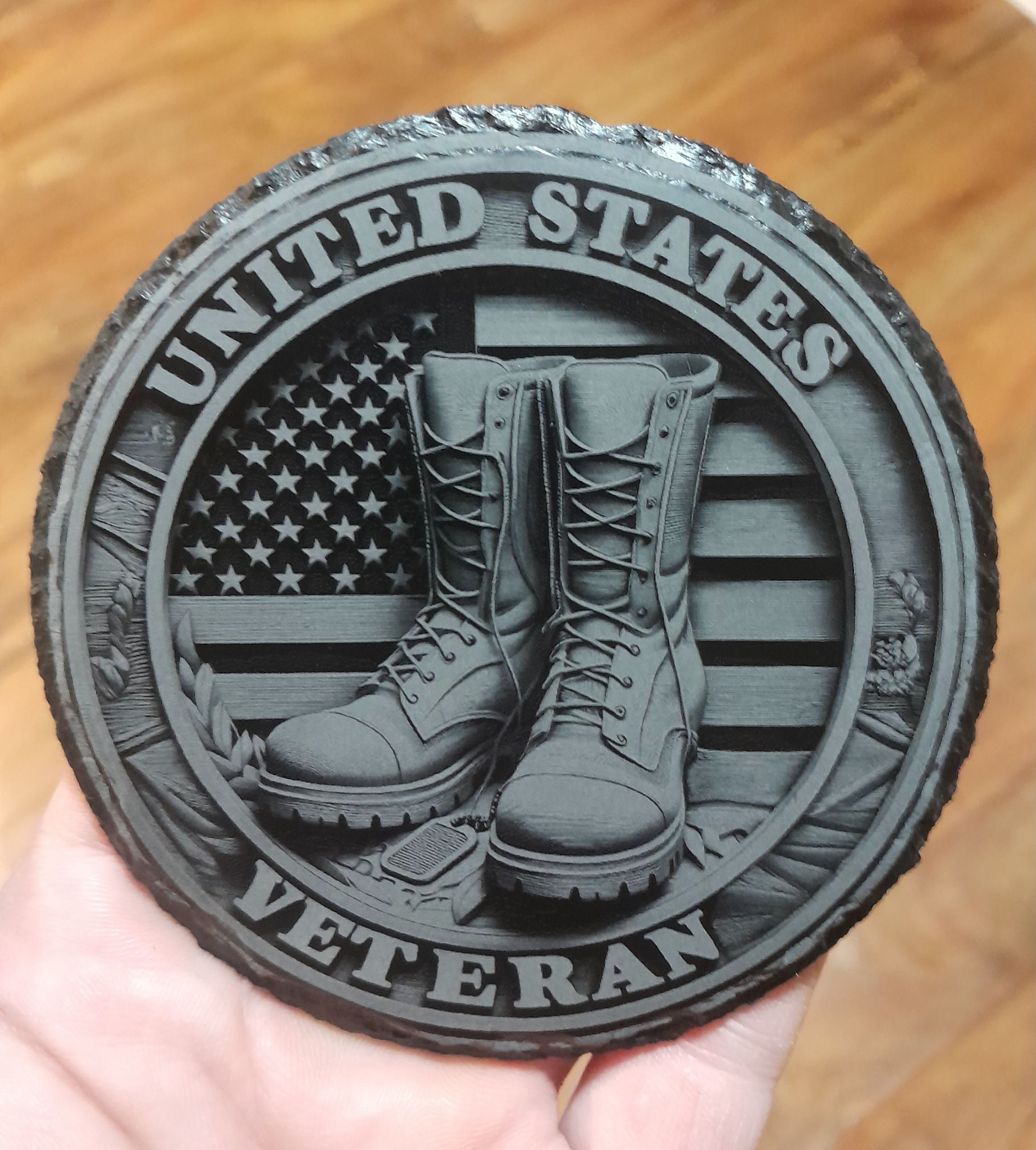 A stone being engraved by a laser machine, emitting a bright light as it etches intricate patterns onto the surface